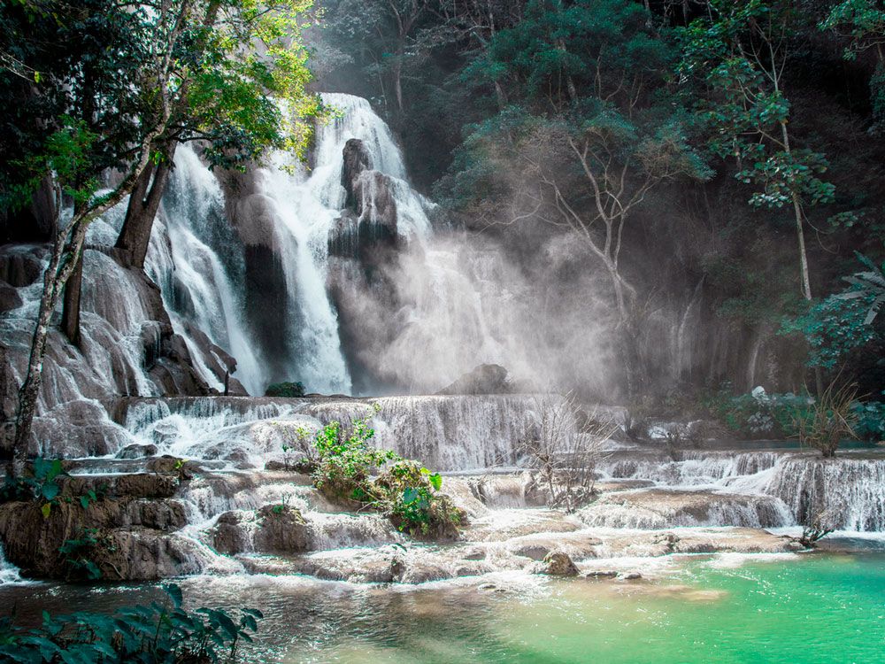 Roaring multi-tiered cascades of Kuang Si Falls in Laos