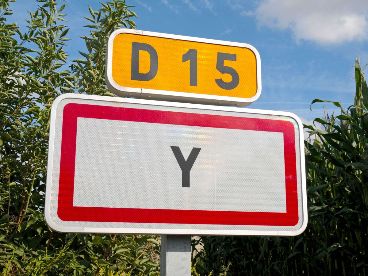 Close-up of road sign indicating Y, France