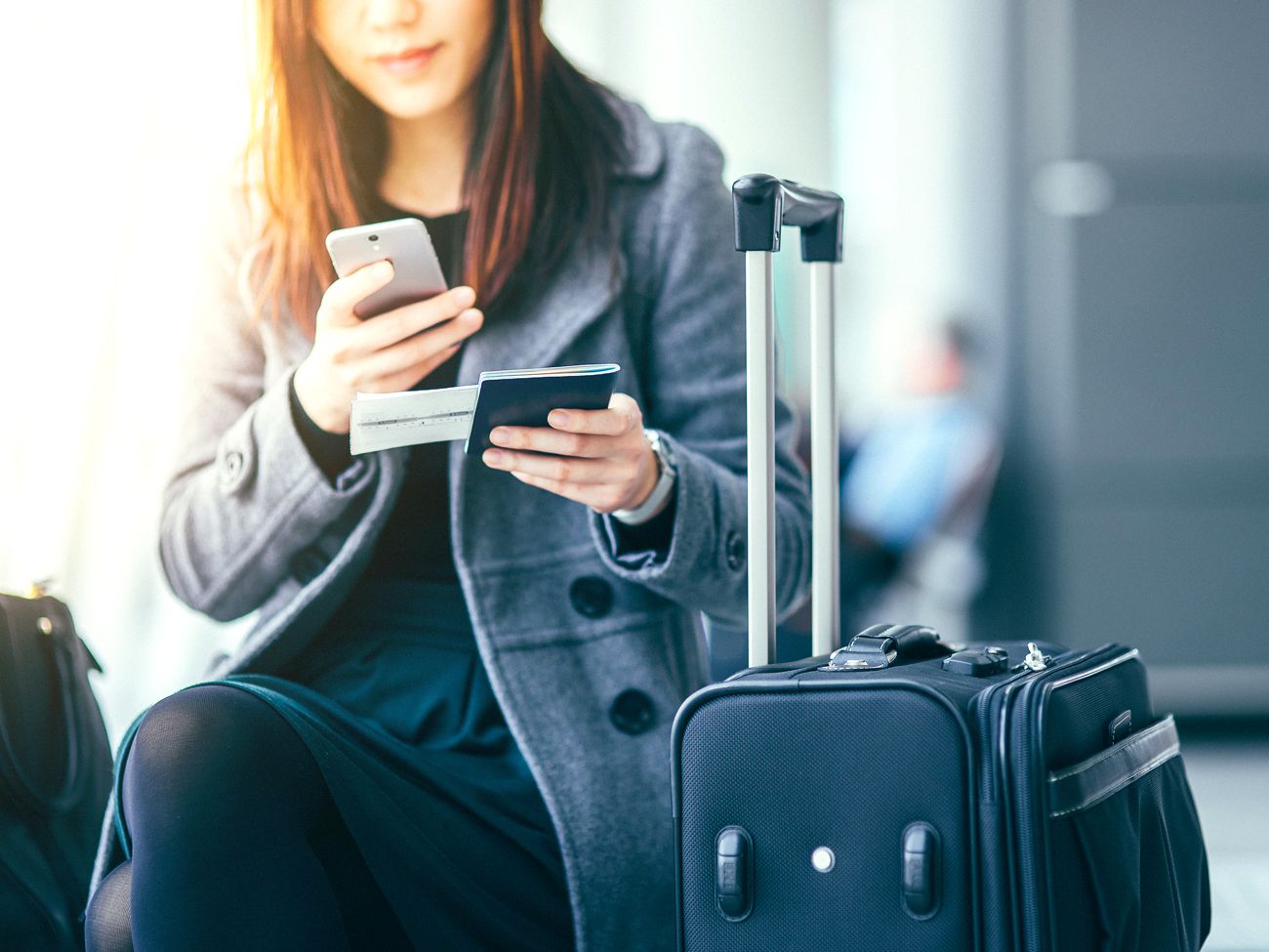 Traveler holding passport and ticket at airport
