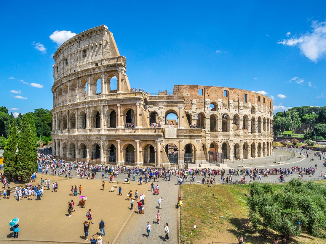 Tourists surround the ruins of the Colosseum in Rome, Italy