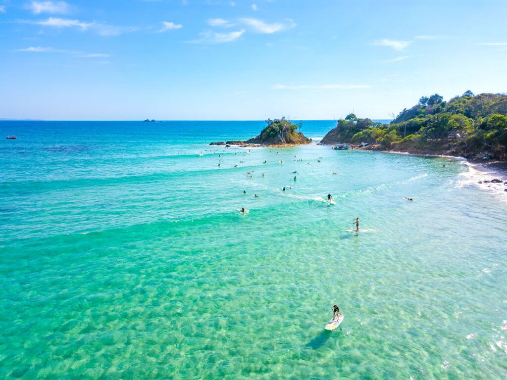 Swimmers and stand-up paddleboarders in Byron Bay, Australia