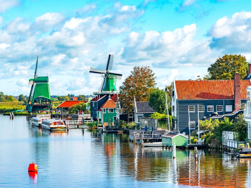 Docks and windmills along river in the Netherlands