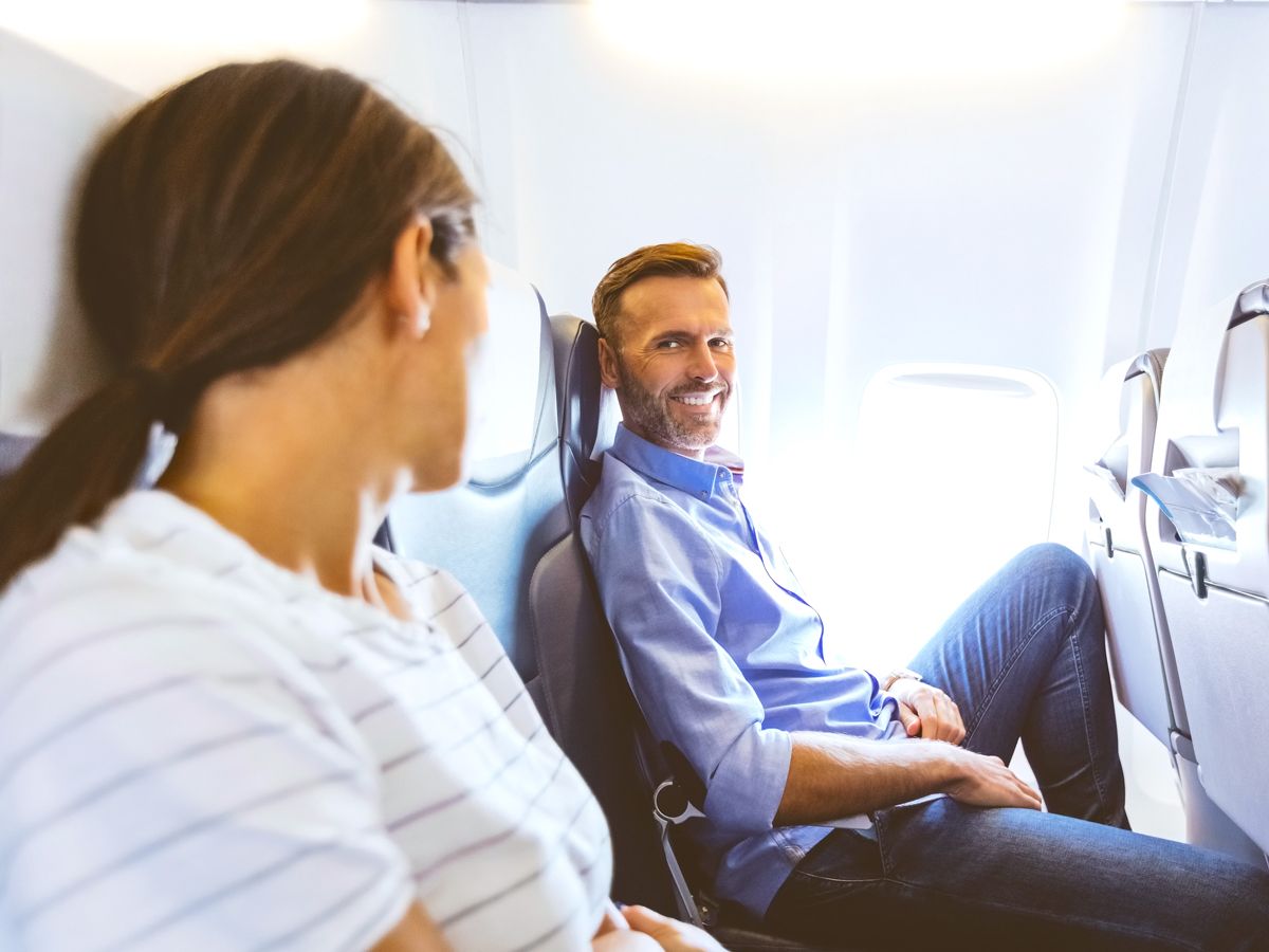 Passengers conversing on airplane