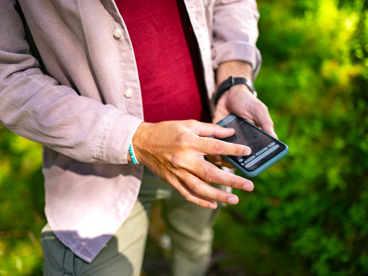 Person using cellphone outdoors