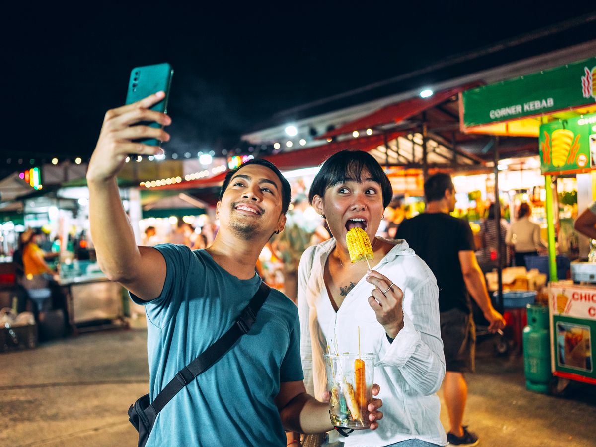 Tourists taking selfie at night market