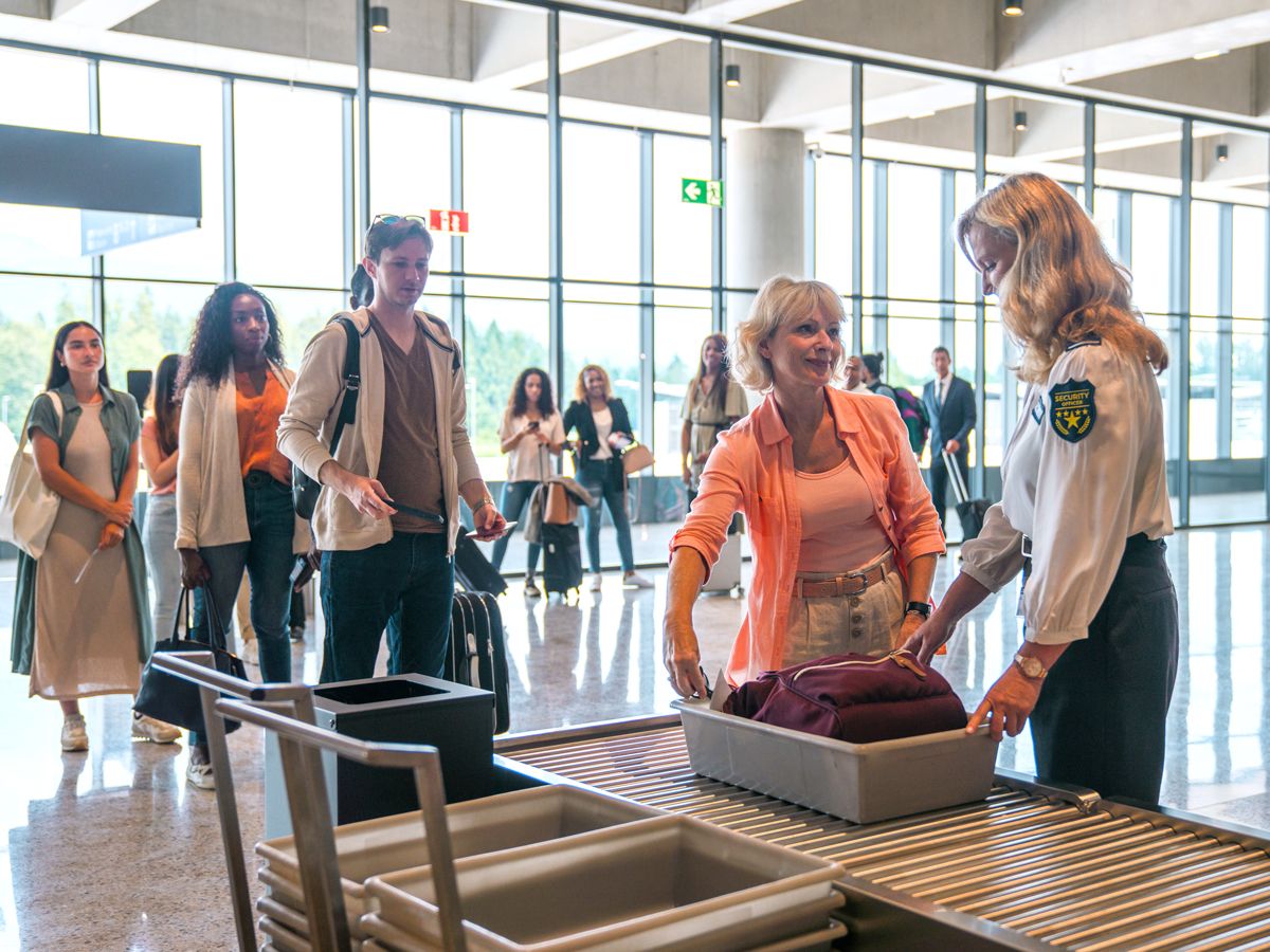 Passengers waiting in line for airport security screening