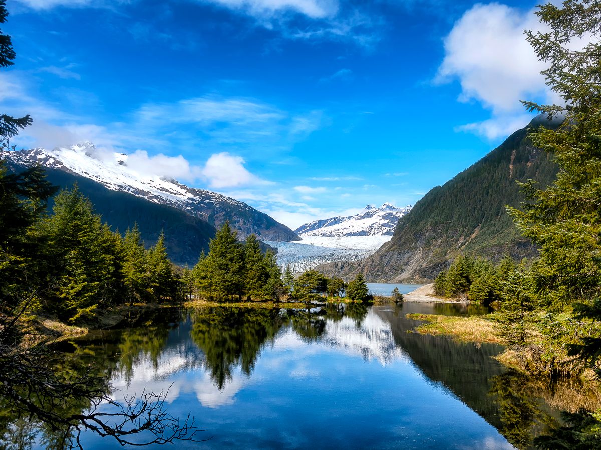 Mountains and trees reflecting on water near Juneau, Alaska
