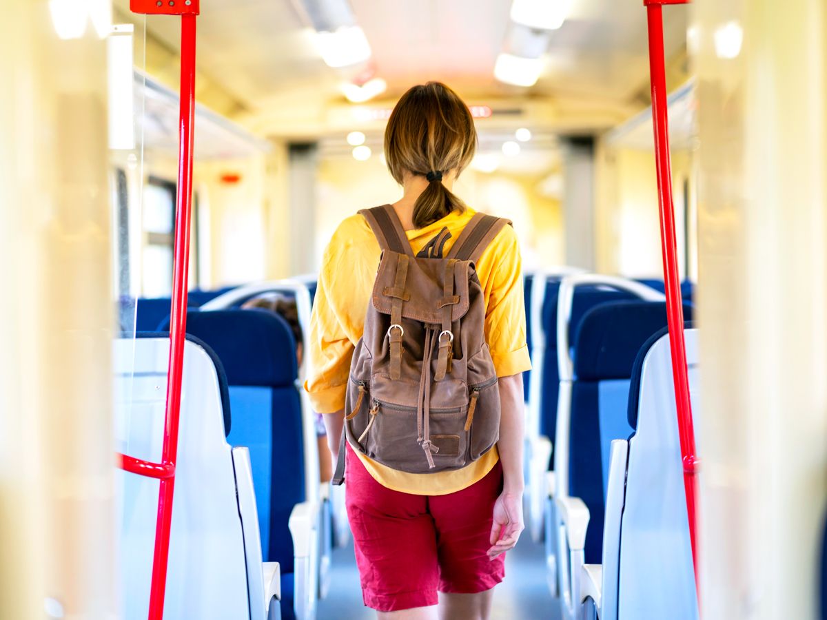 Passenger walking through train car