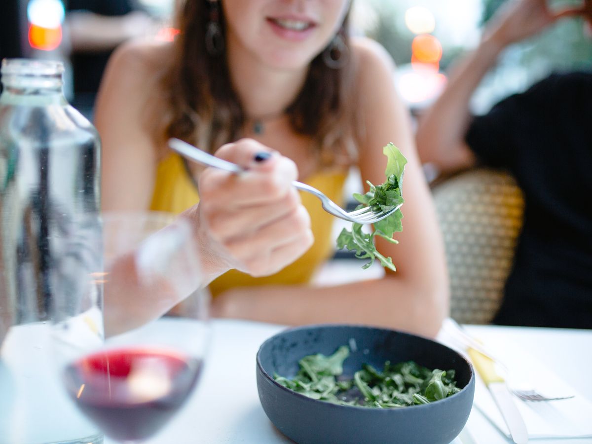 Diner eating arugula salad