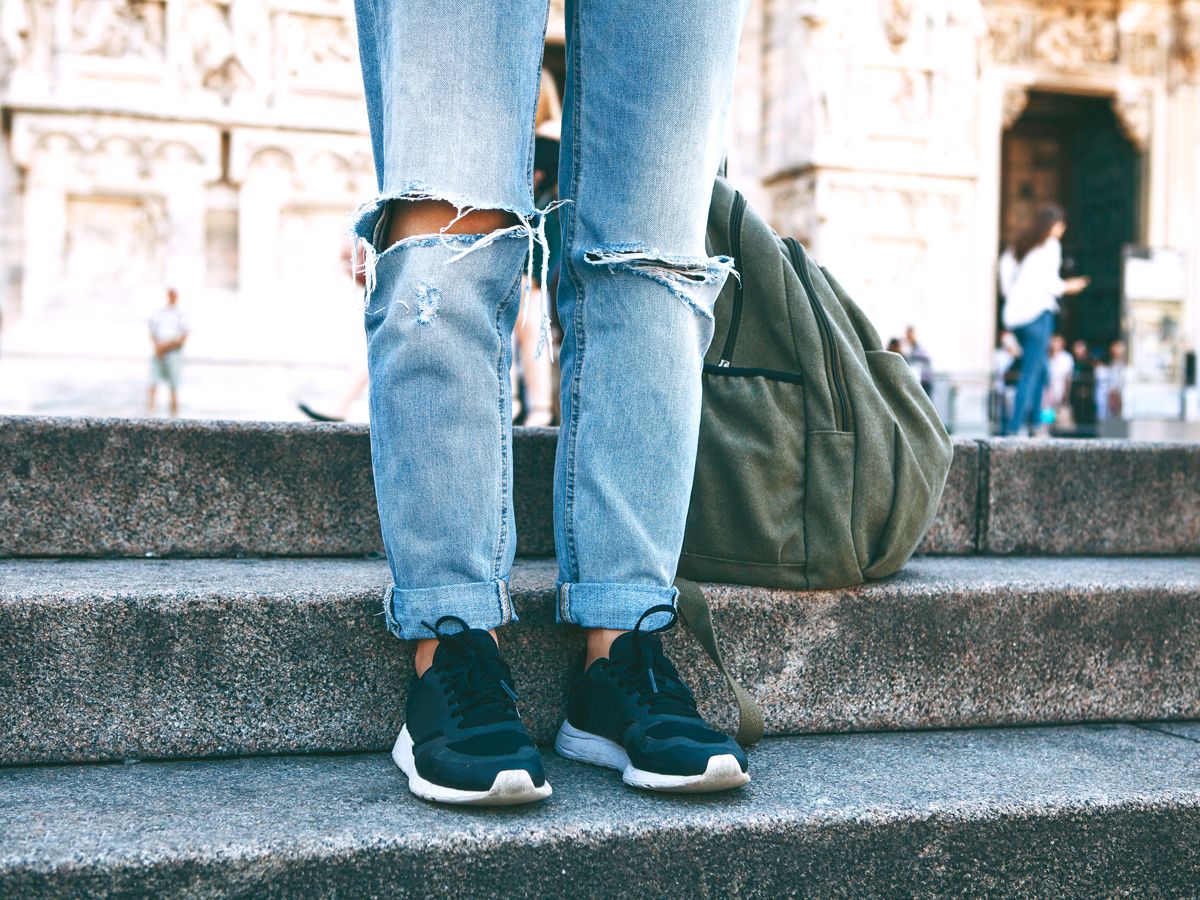 Person wearing ripped jeans