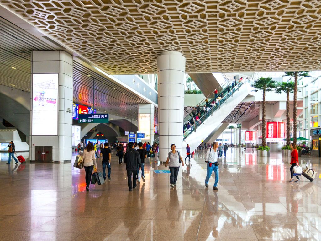 Passengers walking through terminal at Guangzhou Baiyun Airport