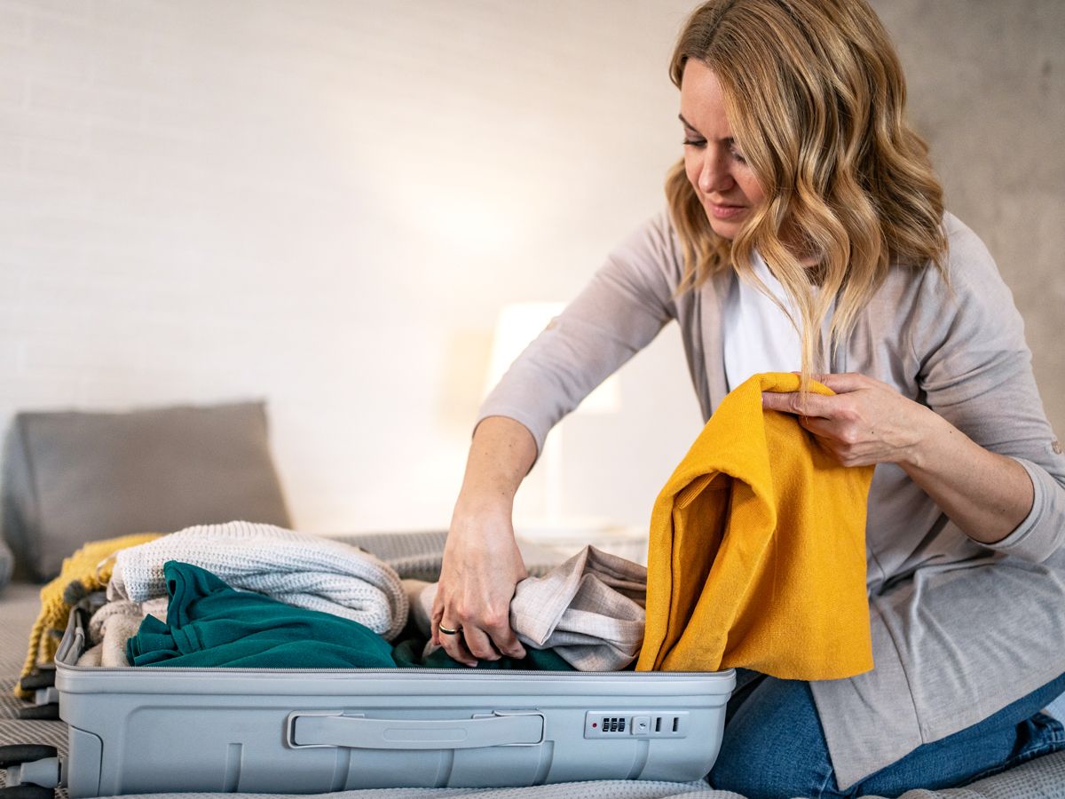 Traveler packing suitcase