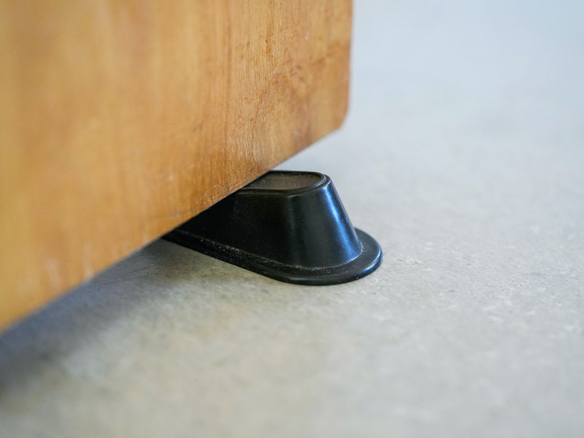 Rubber wedge under door