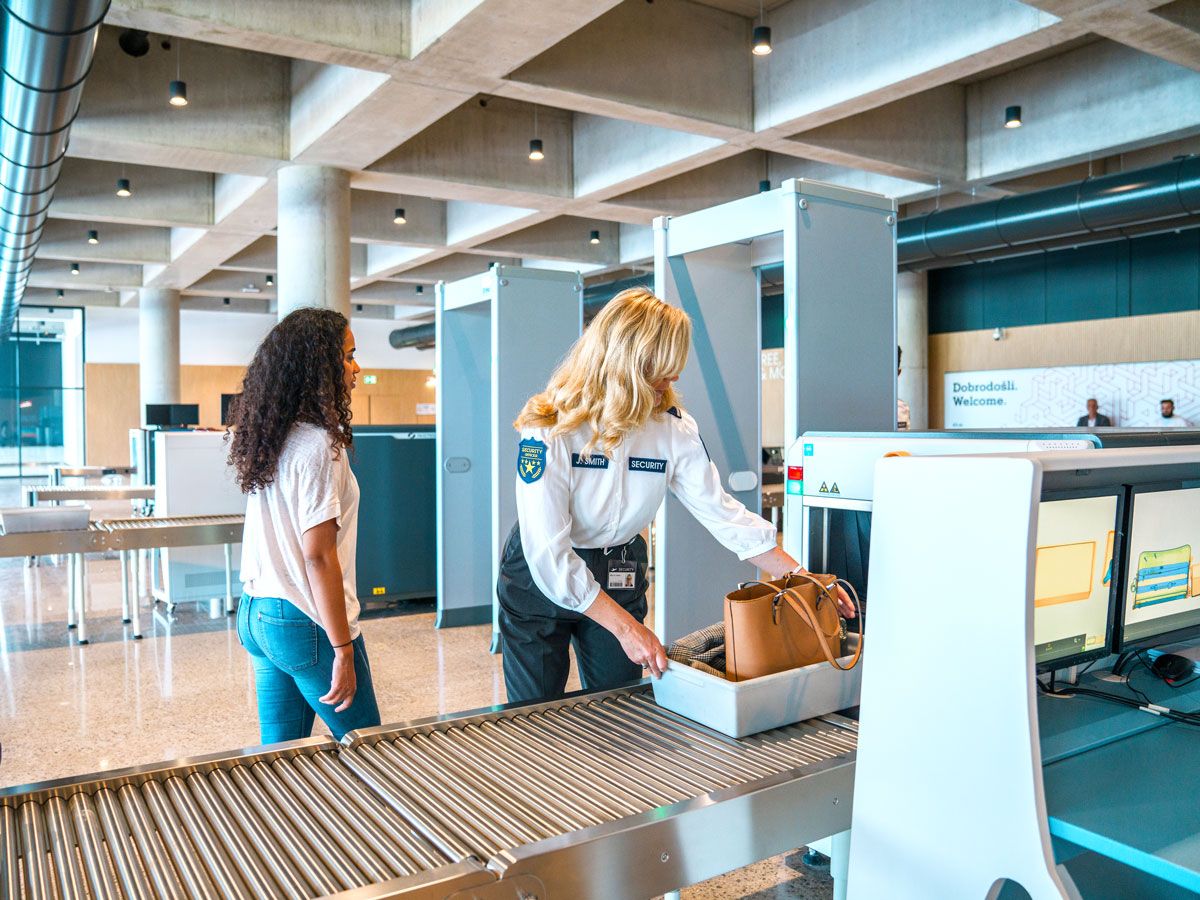 Passenger undergoing security screening at airport