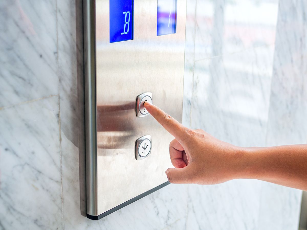 Person pushing "up' button for elevator