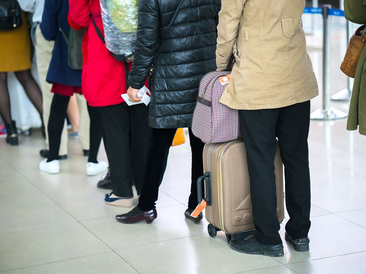 Passengers waiting in line to board aircraft