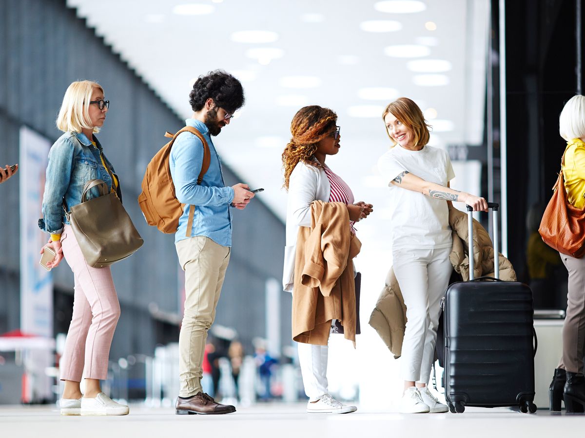 Passengers chatting in line at airport