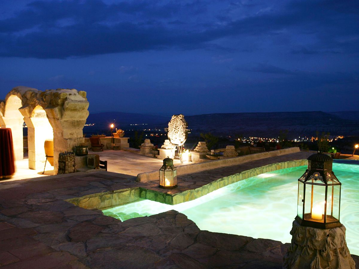 View of pool area and Cappadocia region of Turkey at night from Museum Hotel 