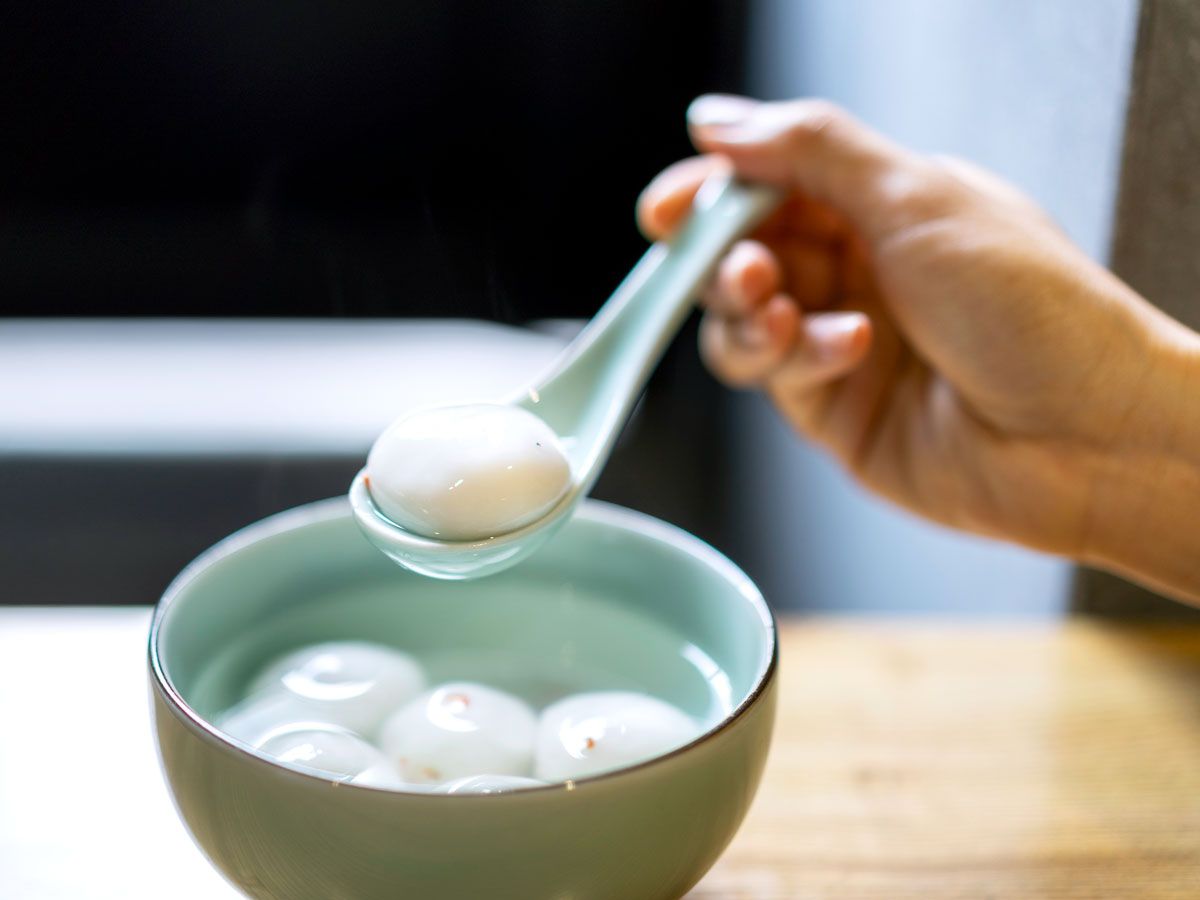 Person eating tang yuan from bowl