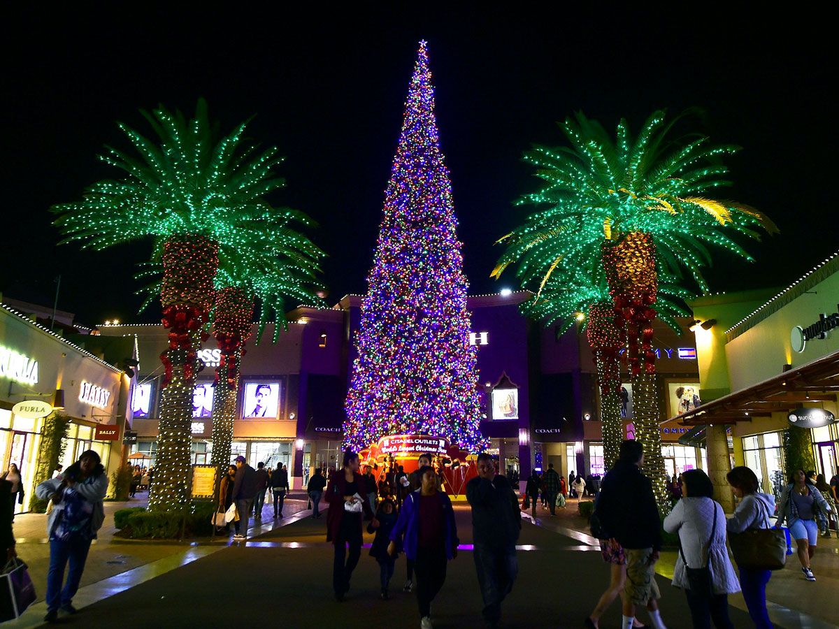 Shoppers walking around the Citadel Outlets Christmas Tree in Commerce, California