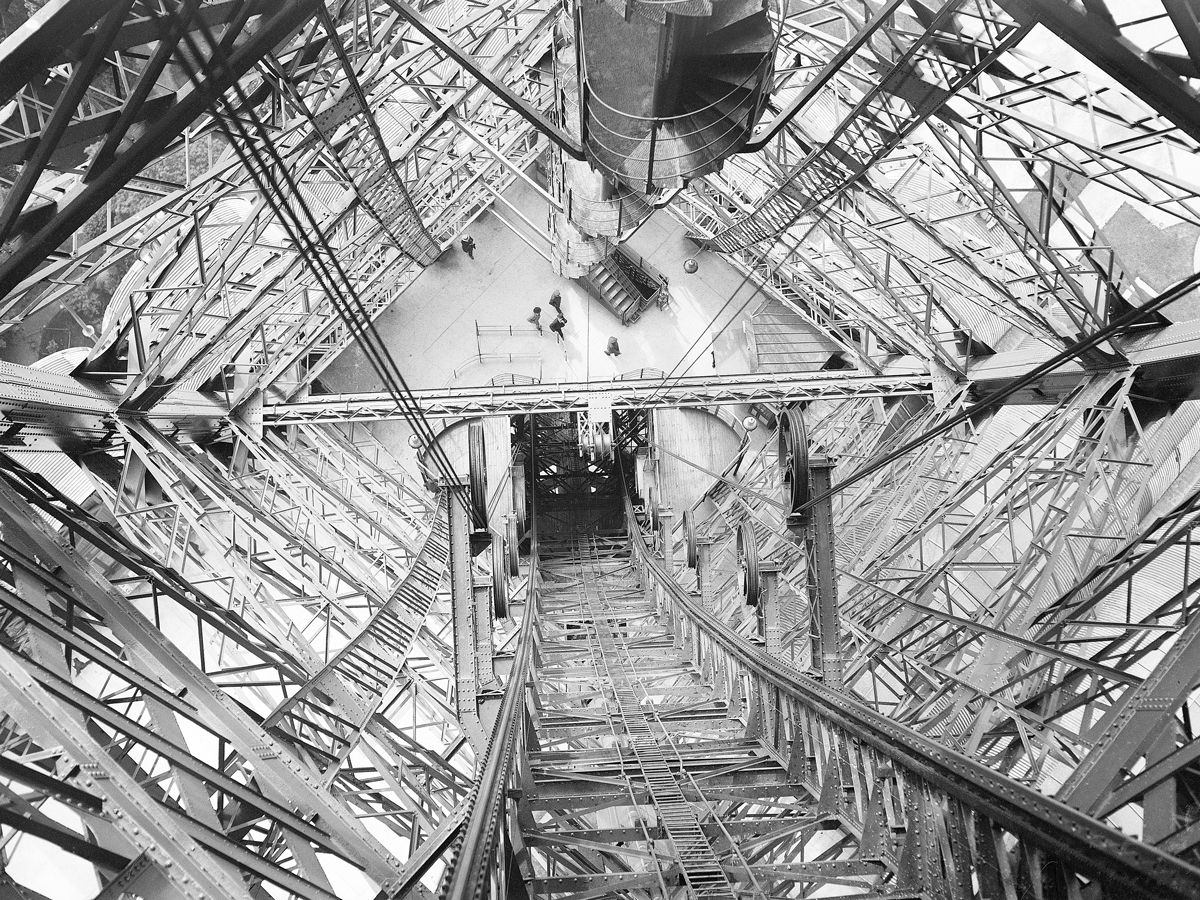 View of iron lattice work inside Eiffel Tower looking down