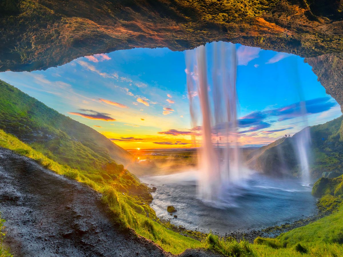 Breathtaking waterfall in Iceland with sunset in background