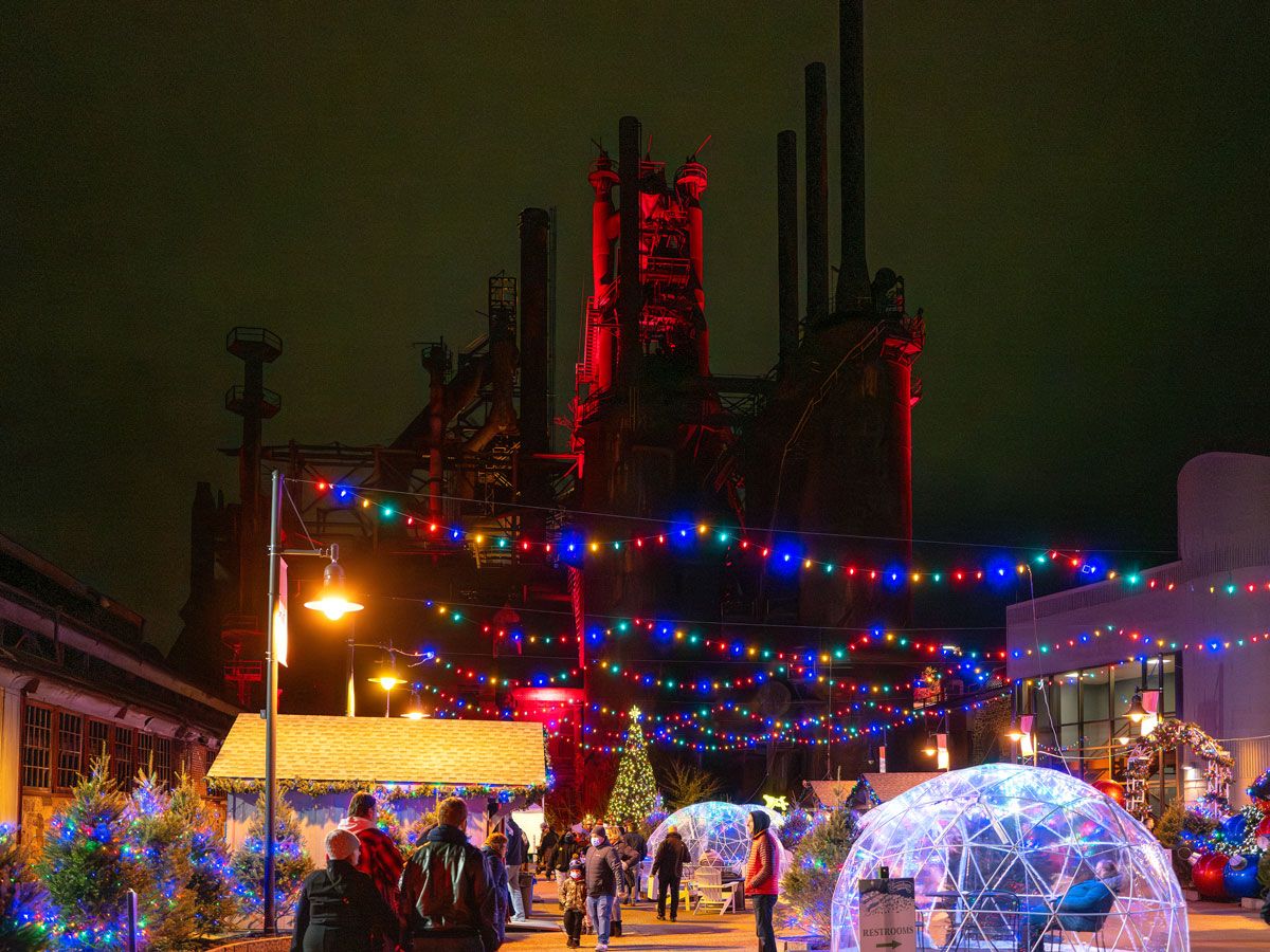 Patrons walking under holiday lights at the Christkindlmarkt in Bethlehem, Pennsylvania