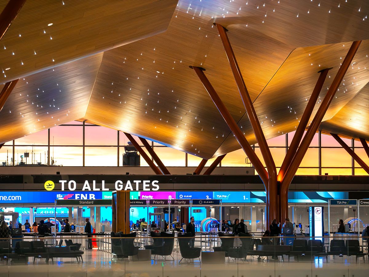 Sign toward all gates under undulating wood ceilings at the new Pittsburgh International Airport