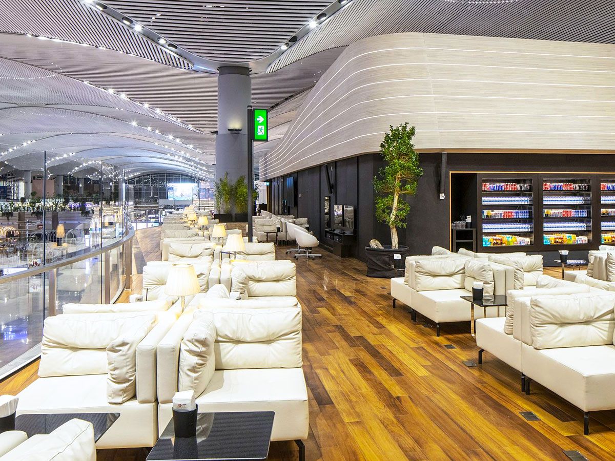 Plush seating in Turkish Airlines Business Class Lounge overlooking terminal at Istanbul Airport