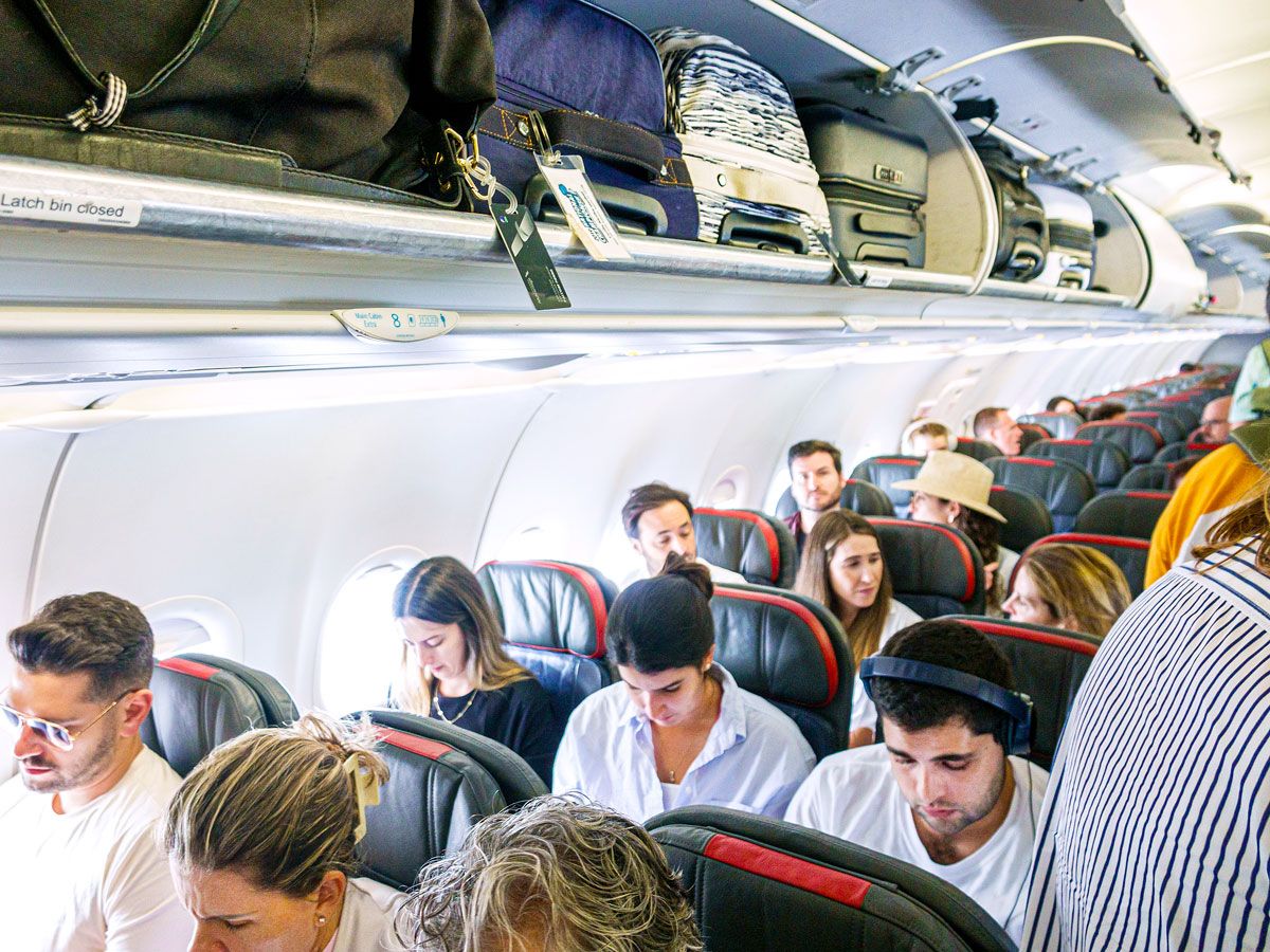 Passengers boarding American Airlines aircraft economy class