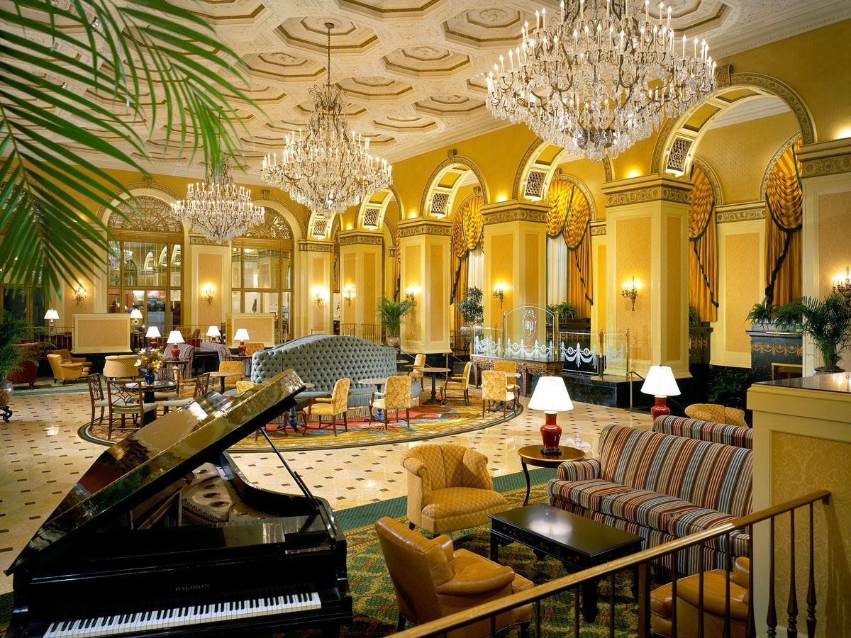 Ornate lobby with piano lounge and chandeliers at an Omni hotel