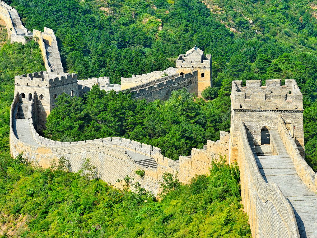 The Great Wall of China winding through forest