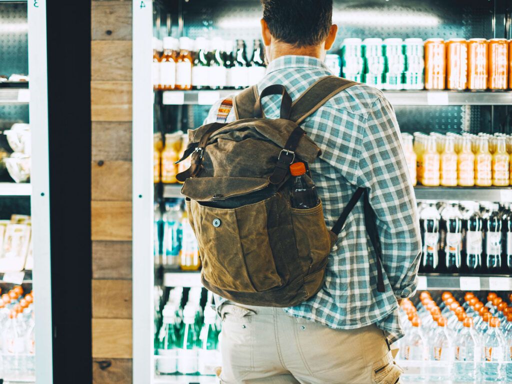 Person browsing beverage display case