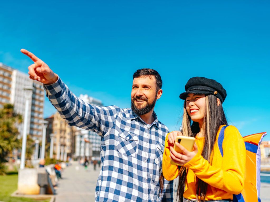 Woman beside man pointing to something in distance