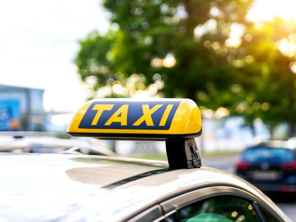Close-up of taxi sign on top of vehicle