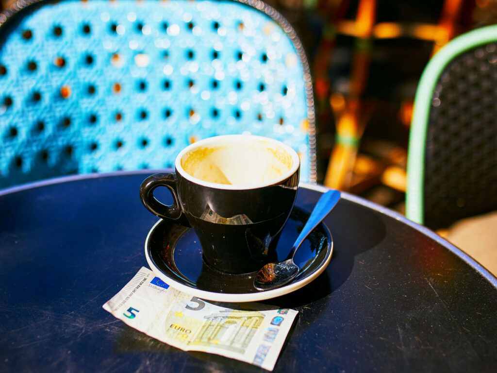 5-euro note under empty cup of espresso