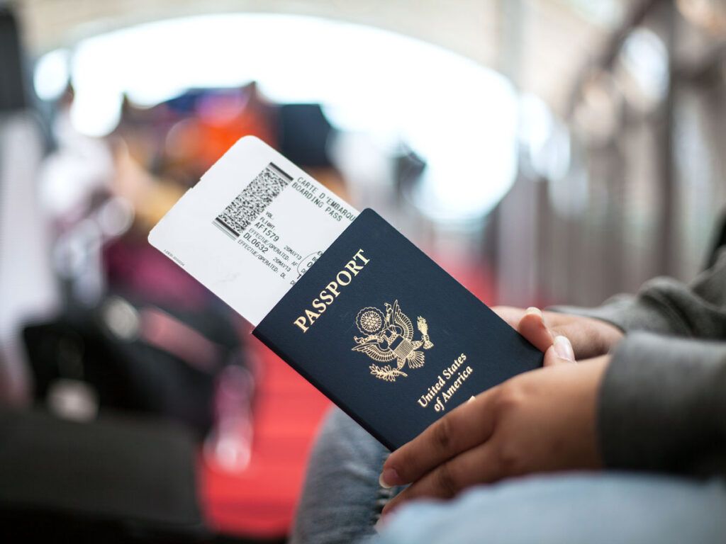 Traveler holding passport and boarding pass
