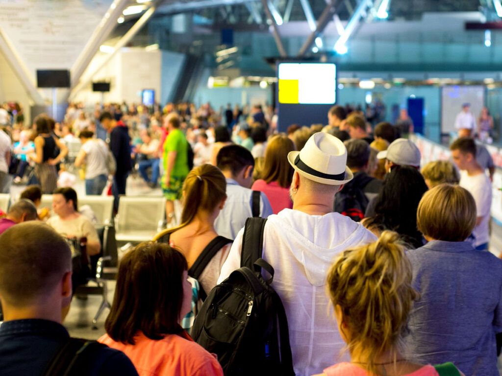 Long lines of travelers in airport terminal