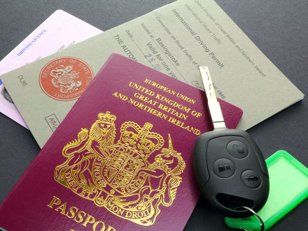 Keys, passport, and International Driving Permit on table
