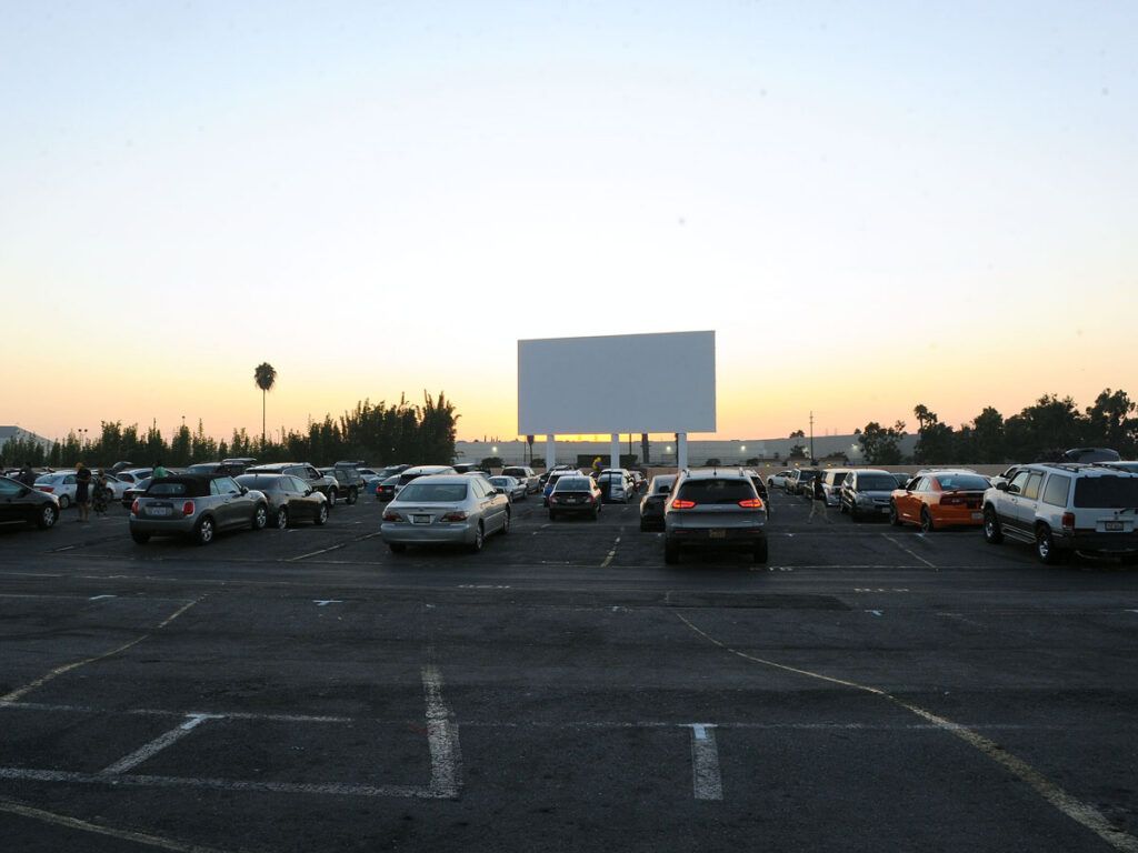 Cars parked in front of screen at Paramount Drive-In Theatres