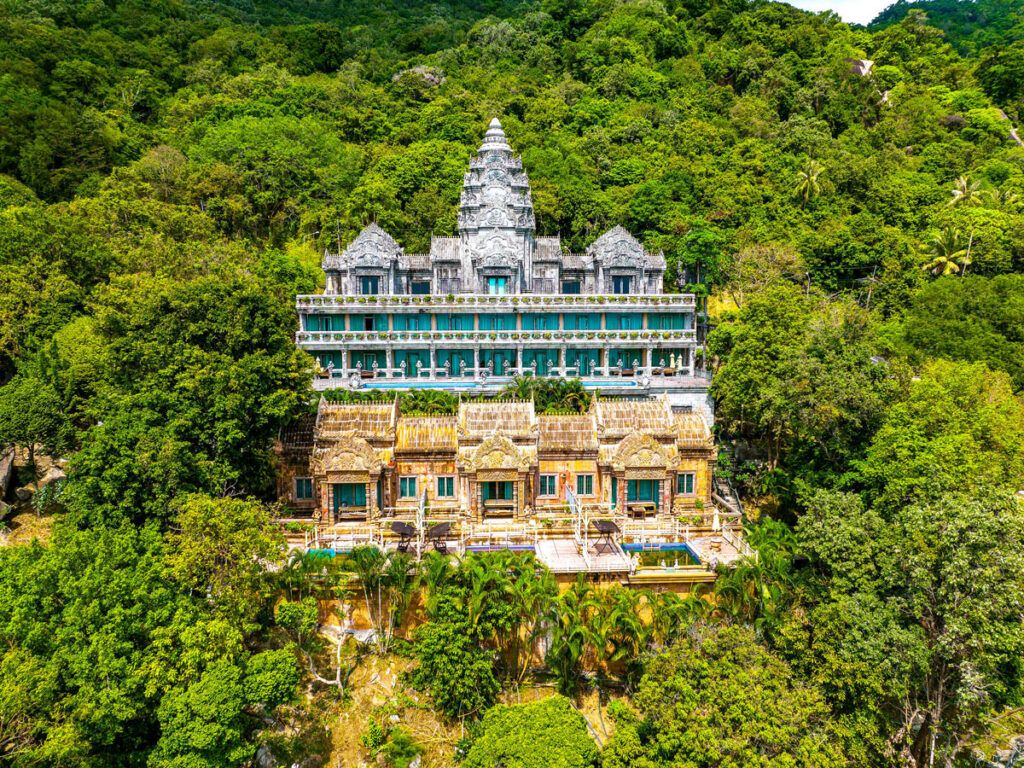 Abandoned Le Palais Hotel surrounded by dense jungle
