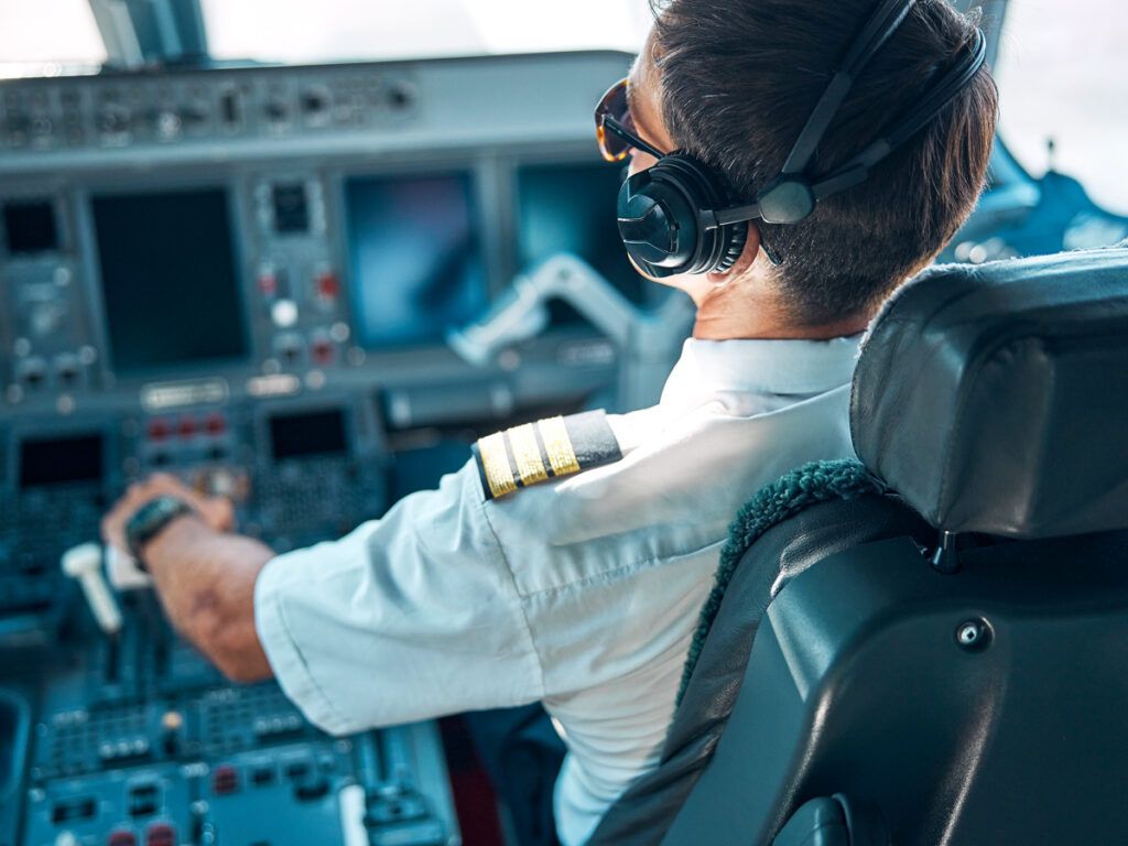 Pilot commanding aircraft from cockpit