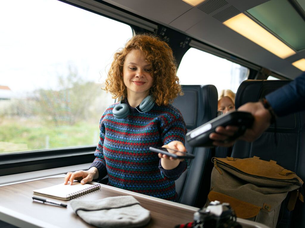 Amtrak rider validating ticket on machine