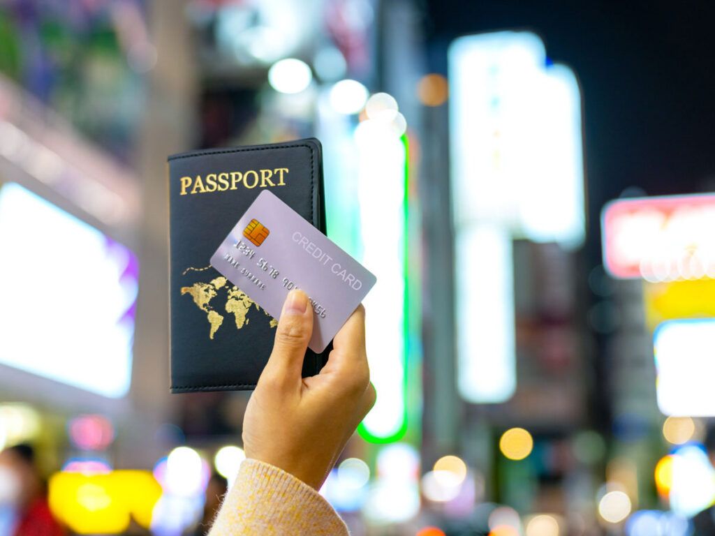 Person holding passport and credit card