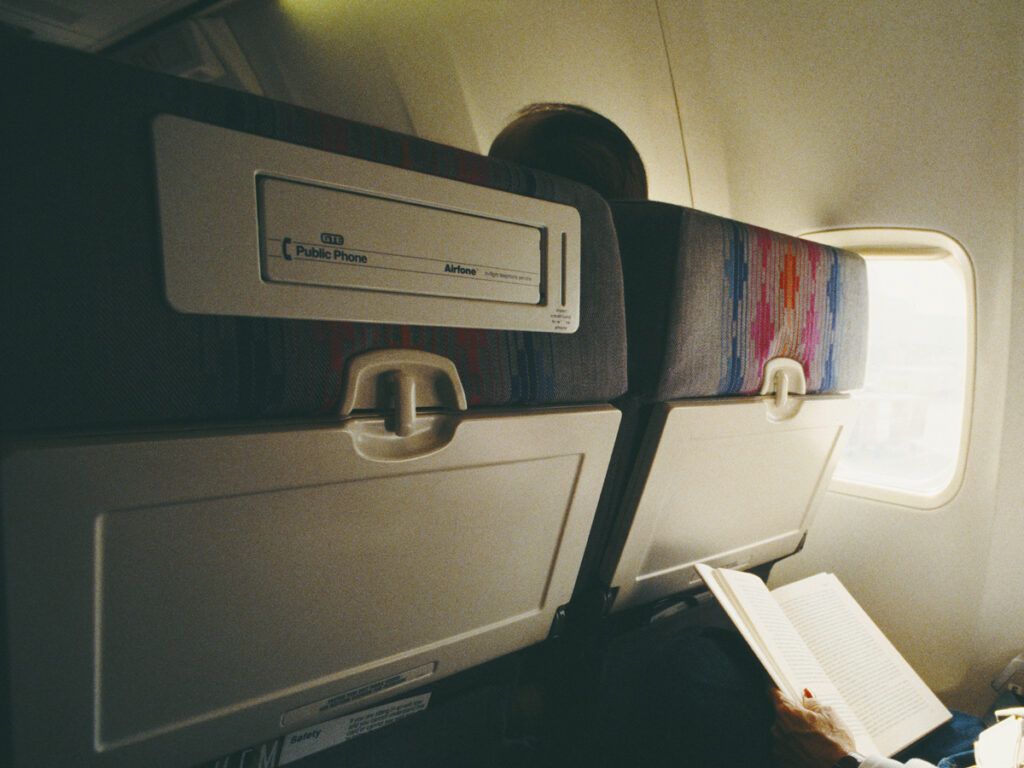 Airplane seat with telephone in headrest