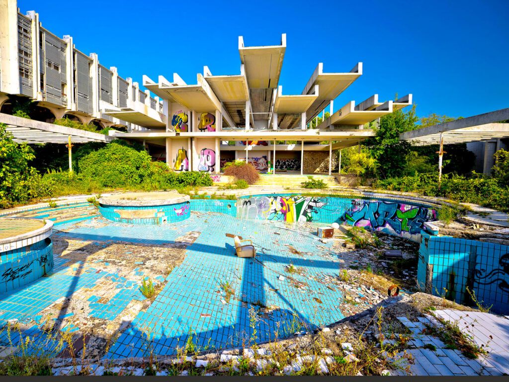 Abandoned pool area covered in graffiti at Haludovo Palace Hotel