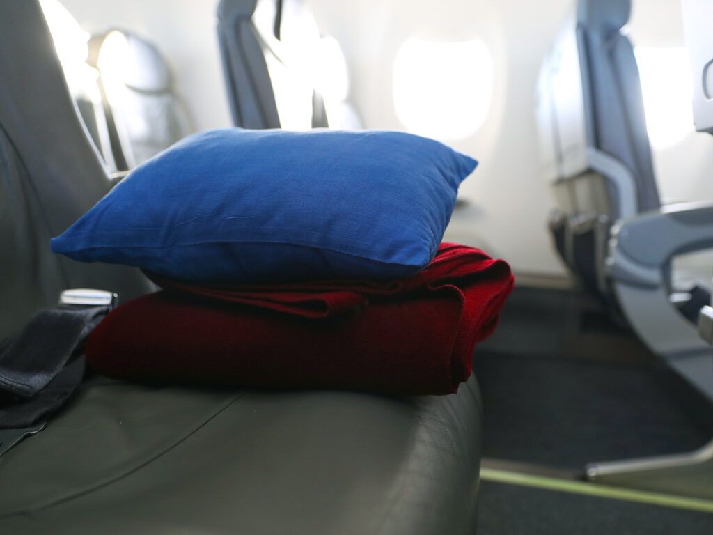 Pillow and blanket on airplane seat
