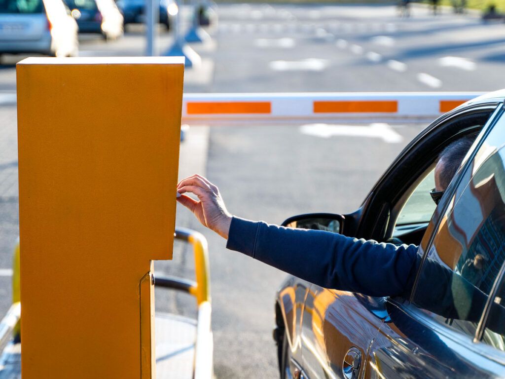 Driver taking ticket from parking lot