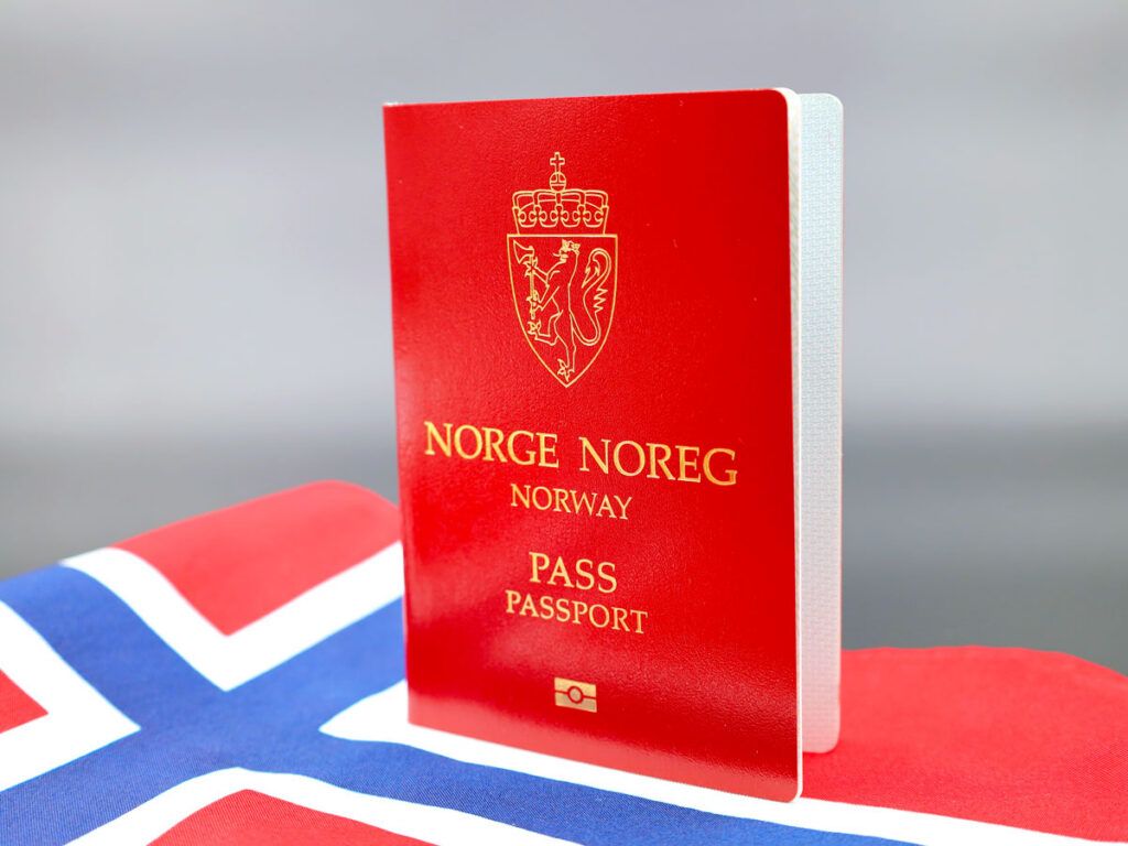 Norwegian passport atop national flag