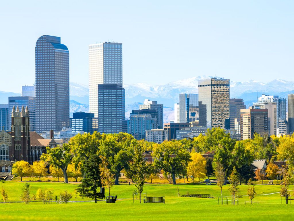 Park with Denver skyline and Rocky Mountains in background